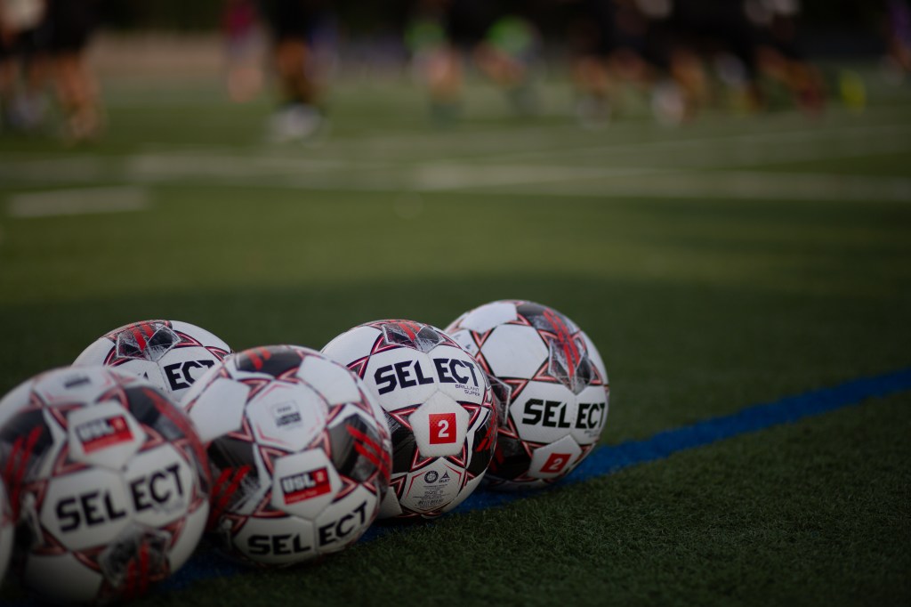USL League Two soccer balls on the pitch, links to about USL2